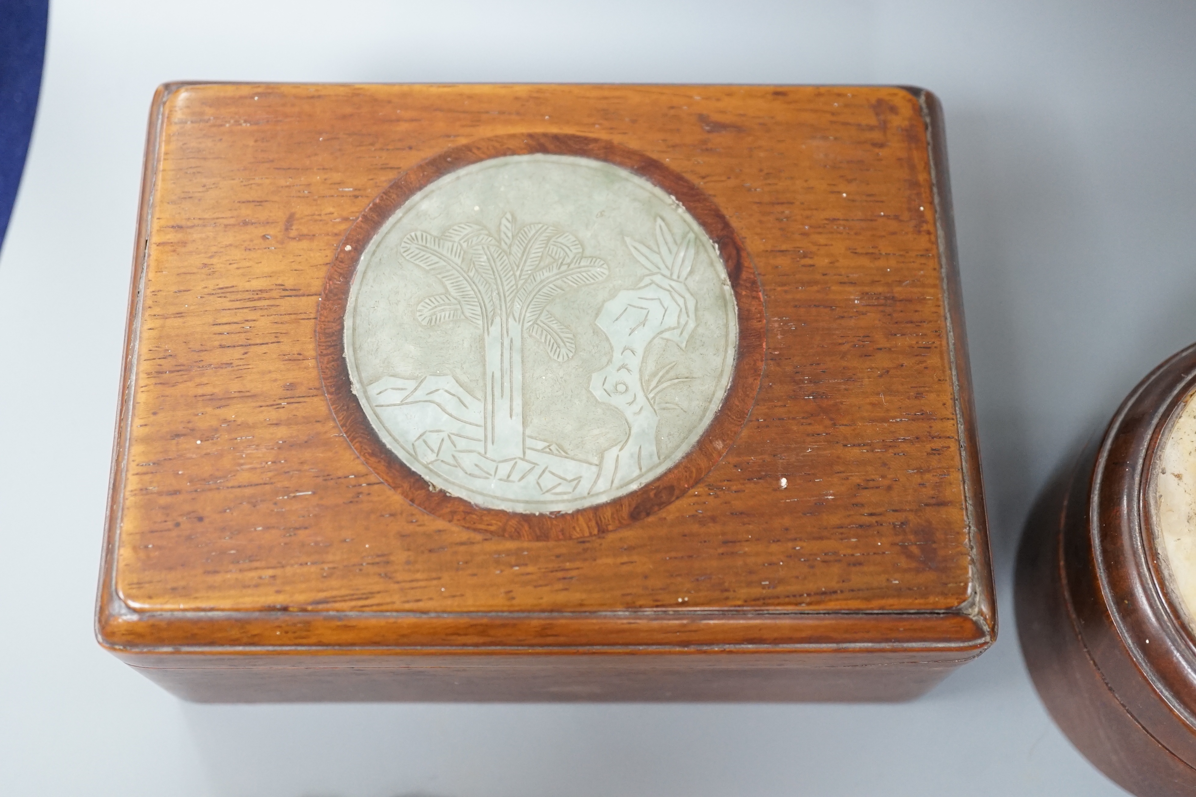 Two 19th century Chinese hardstone inset hardwood boxes and an embroidered amulet charm, largest box 12.5cm
